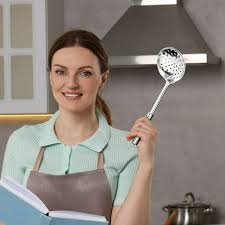 <p>The woman is holding a kitchen utensil.</p>