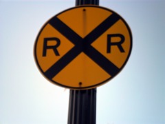 <p>Many railroad crossings have signs or signals to warn drivers. The round</p><p>advance warning sign tells you that you are nearing a railroad crossing.</p><p>Never start to cross the tracks</p><p>until there is room for your vehicle on the other side of the tracks. It is not</p><p>wise to shift gears when crossing railroad tracks, just in case your vehicle</p><p>might stall.</p>