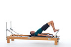 <p><strong>Setup</strong></p><ul><li><p>Lying supine in neutral spine position, legs parallel, feet hip width apart, toes placed on footbar, knees bent, arms by sides, headrest down</p></li><li><p>Resistance: medium | <strong>Springs: 2R (or 2R + 1B)</strong></p></li></ul><p><strong>Movement</strong></p><ul><li><p>Exhale: Roll spine up</p></li><li><p>Inhale: Pause</p></li><li><p>Exhale: Roll spine down</p></li><li><p>Inhale: Pause</p></li></ul><p><strong>Muscle Focus</strong></p><ul><li><p>Spinal flexors</p></li><li><p>Hip extensors</p></li></ul><p><strong>Objectives</strong></p><ul><li><p>Spinal articulation</p></li><li><p>Hip extensor control</p></li></ul><p><strong>Cues</strong></p><ul><li><p>Feet position is same as Parallel Toes in Footwork (page 18)</p></li><li><p>Keep heels still, adductors engaged and legs parallel</p></li><li><p>Minimize movement of carriage when rolling spine up and down</p></li><li><p>Articulate through each vertebra as spine rolls up and down</p></li></ul><p></p>
