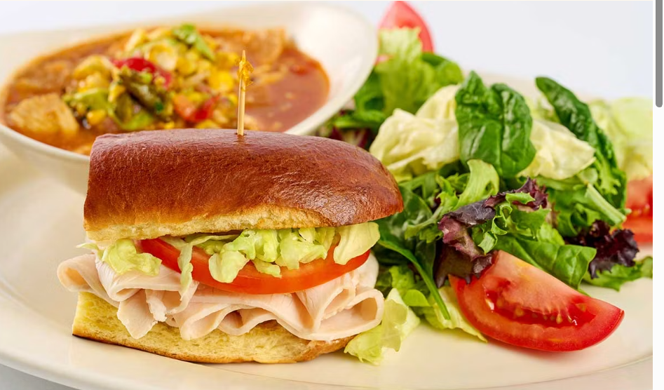 <p>One-Half of a Fresh Turkey Sandwich, a Cup of Our Soup and a Small Green Salad</p>