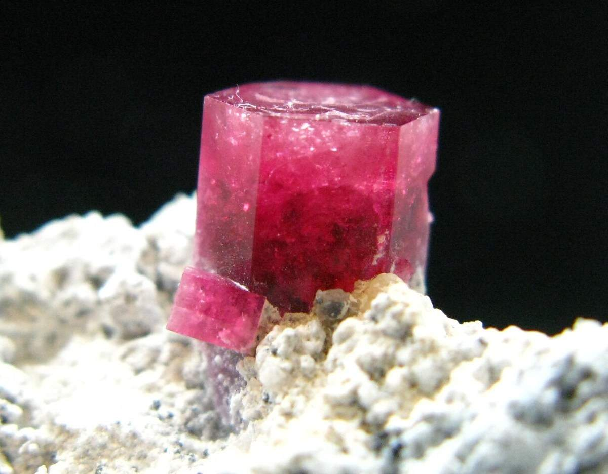 <p><strong>Bixbite,</strong> also known as red beryl, is one of the rarest gemstones on Earth, even rarer than diamonds. Its <strong>vivid red color</strong> results from the substitution of which ion for aluminum (Al³⁺) in the crystal lattice?</p>