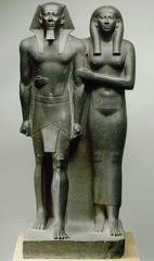 <p>Form:</p><p>-greywacke</p><p>-under life-size</p><p>-symmetrical</p><p>-Egyptian style: one foot in front of the other</p><p>Content:</p><p>-king and queen same height, idealized figures</p><p>-pharaoh crown</p><p>-wife gives simple affectionate gesture</p><p>Function:</p><p>-temple sculpture</p><p>-symbolize his power and kingship</p><p>Context:</p><p>-Old Kingdom 2500 BCE</p>