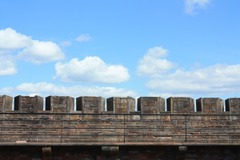 <p>A ___ is a pattern of multiple openings/notches along the top of a defensive wall, arrows/other weapons can be shot from here, while higher parts protect soldiers</p>