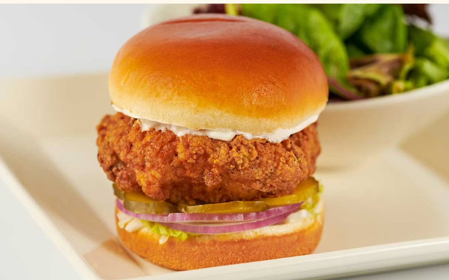 <p>Chicken Breast Fried Crisp with Lettuce, Pickles and Onions on a Toasted Bun. Served with a Green Salad</p>