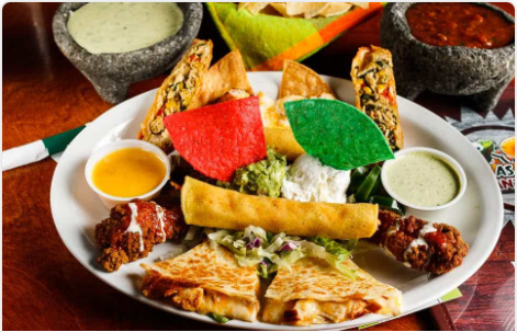 <p>(2) Chicken nachos, (2) Tex-Mex egg rolls, (2) chicken quesadillas, (2) taquitos, and (2) Buffalo wings. Served with sour cream, guacamole, jalapenos, and queso</p>