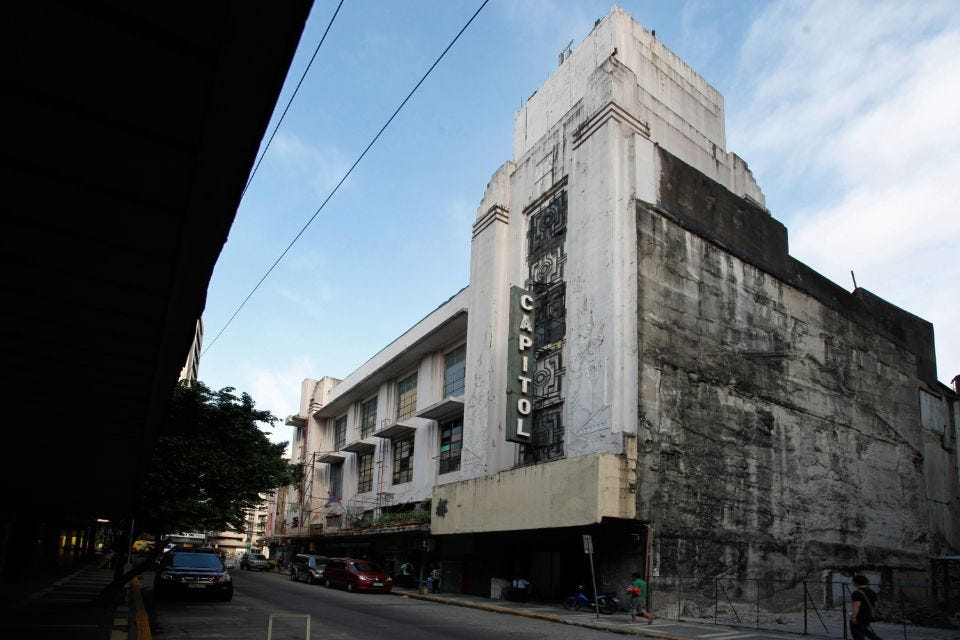<ul><li><p><span style="background-color: transparent;">Situated in Escolta in Binondo, designed by Juan Nakpil, and built in 1935.</span></p></li><li><p><span style="background-color: transparent;">With the strong presence of symmetry, geometric shapes, and the occasional presence of</span></p></li><li><p><span style="background-color: transparent;">graceful curves, the design is strongly identified with the Art Deco visual arts design style which was very popular during the 1930s.</span></p></li></ul><p></p>