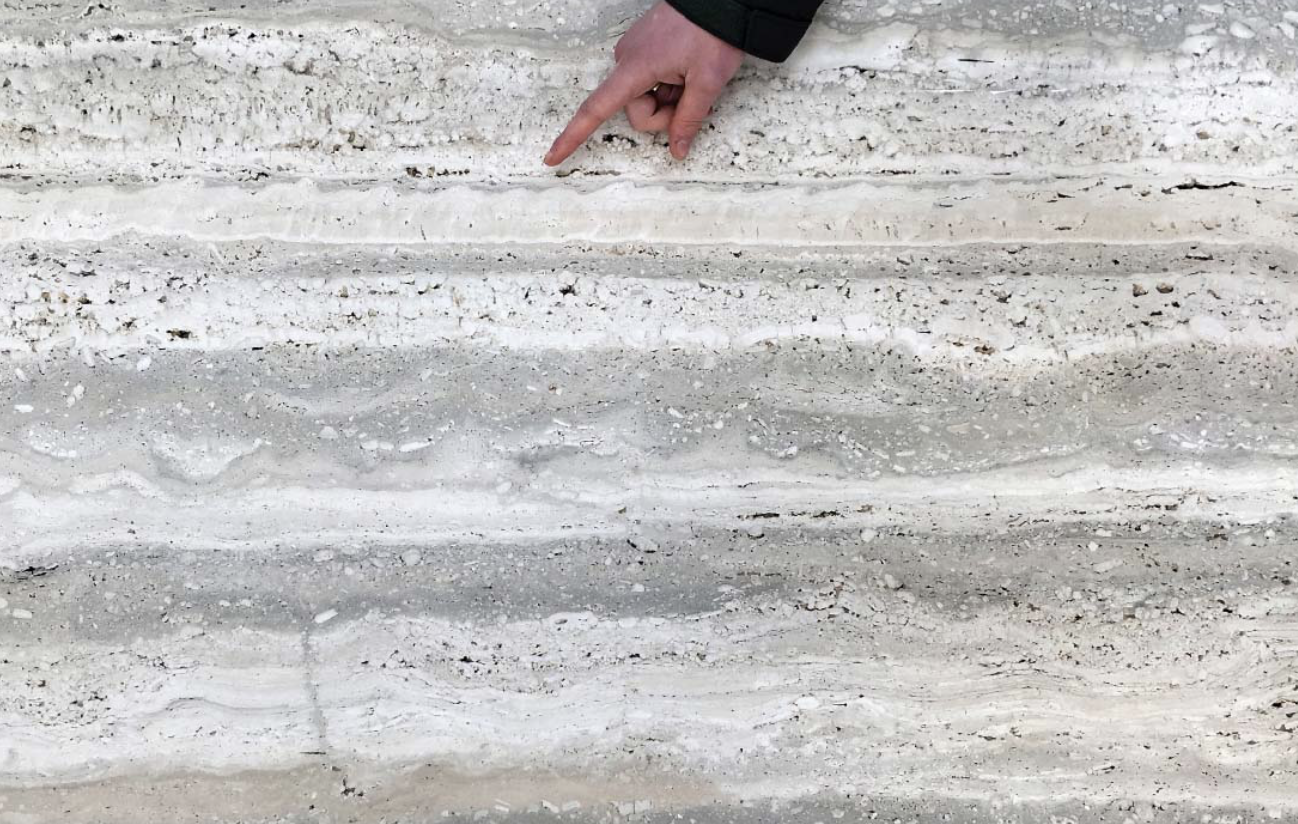 <p>a rock composed of crystalline calcium carbonate (CaCO<sub>3</sub>) formed by chemical precipitation from groundwater that has seeped out at the ground surface either in hot- or cold-water springs, or on the walls of caves</p><ul><li><p>has distinct layering making it a popular stone for construction</p></li></ul><p></p>