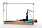 <p><strong>Setup</strong></p><ul><li><p>Lying supine, heel of one foot placed on PTBar, leg bent, other leg placed on mat, leg straight, foot plantarflexed</p></li><li><p>Resistance: medium <strong>[bottom loaded] 1 spring + safety belt</strong></p></li></ul><p><strong>Movement</strong></p><ul><li><p>Exhale: Straighten leg</p></li><li><p>Inhale: Bend leg, return to start position</p></li></ul><p><strong>Muscle Focus</strong></p><ul><li><p>Hip extensors</p></li><li><p>Knee extensors</p></li></ul><p><strong>Objectives</strong></p><ul><li><p>Hip extensor strength and stretch</p></li><li><p>Hip flexor stretch (supporting leg)</p></li><li><p>Knee extensor control</p></li><li><p>Pelvic lumbar stabilization</p></li></ul><p><strong>Cues</strong></p><ul><li><p>Maintain hip extensor engagement</p></li><li><p>Maintain pelvic lumbar stabilization</p></li><li><p>Reach heel toward ceiling when straightening leg</p></li><li><p>Avoid excessive knee flexion (maximum 90 degrees)</p></li><li><p>Straighten leg completely, avoiding hyperextension</p></li></ul><p></p>