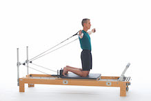 <p><strong>Setup</strong></p><ul><li><p>Kneeling in upright position on carriage, facing footbar, feet against shoulder rests, arms straight by sides of body, hands in straps, palms facing forward</p></li><li><p>Resistance: light | <strong>Springs: 1Y or 1R</strong></p></li></ul><p><strong>Movement</strong></p><ul><li><p>Exhale: Lift arms forward and up, rotate arms, palms face forward</p></li><li><p>Inhale: Circle arms out to T position, lower arms to sides of body, return to start position</p></li></ul><p><strong>Muscle Focus</strong></p><ul><li><p>Shoulder flexors</p></li><li><p>Shoulder abductors</p></li><li><p>Spinal flexors</p></li><li><p>Spinal extensors</p></li></ul><p><strong>Objectives</strong></p><ul><li><p>Shoulder flexor strength</p></li><li><p>Shoulder abductor control</p></li><li><p>Trunk stabilization</p></li></ul><p><strong>Cues</strong></p><ul><li><p>Keep the movement fluid</p></li><li><p>Maintain upright position of trunk</p></li><li><p>Bias towards posterior tilt of pelvis</p></li><li><p>Keep arms in peripheral vision when circling around</p></li><li><p>Reach overhead position prior to rotating arms</p></li></ul><p></p>
