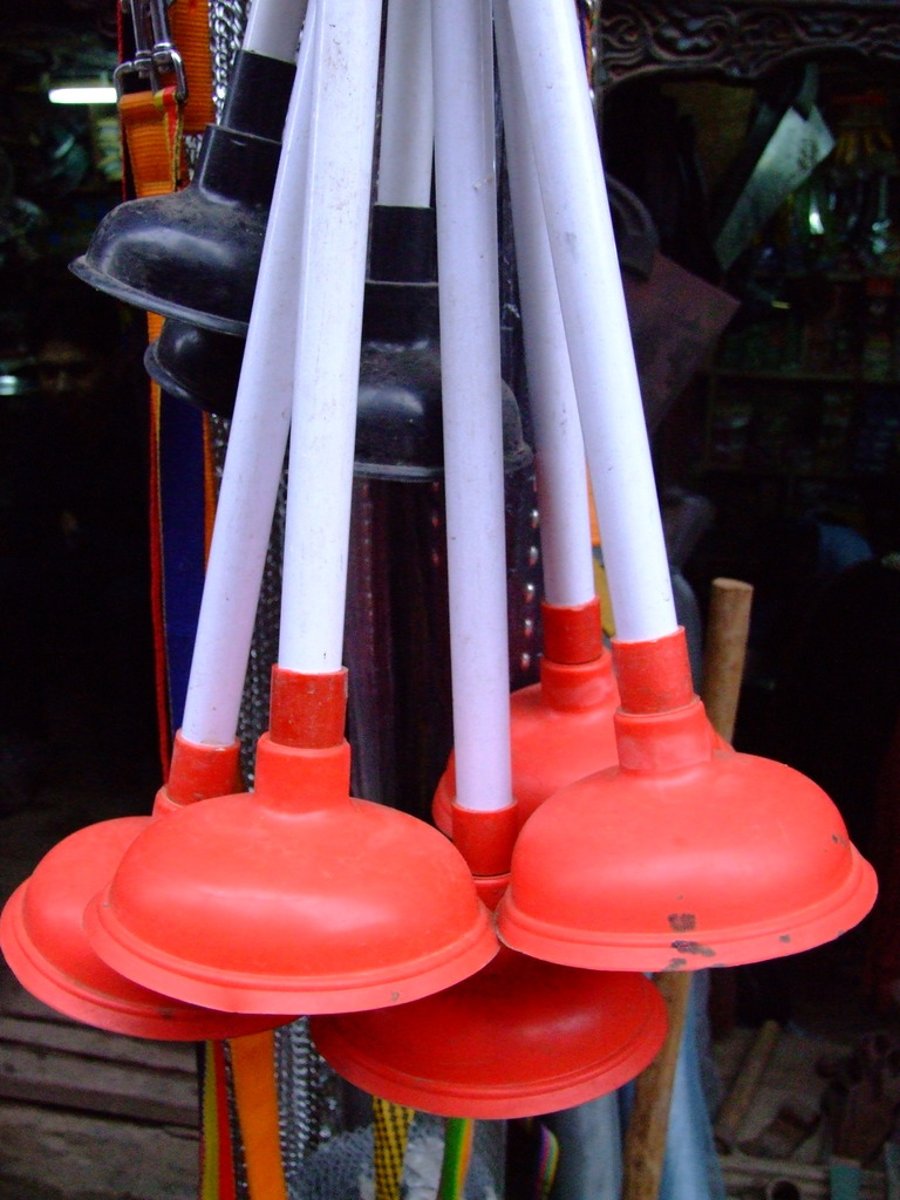 <p>A tool consisting of a rubber cup on a handle, used for clearing blockages in pipes and toilets.</p><p>Example: The kitchen sink is blocked, where is the plunger?</p>