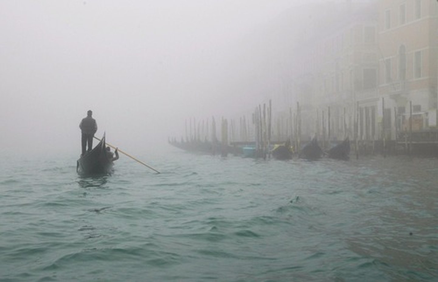 <p>with clouds of small drops of water in the air, making it difficult to see things in the distance</p>
