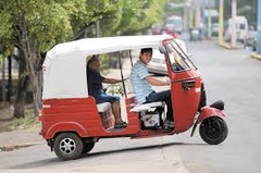 <p>three-wheel motorcycle taxi with a roof</p>