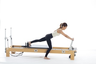 <p><strong>Setup</strong></p><ul><li><p>Standing, one foot on floor, leg bent, other foot against shoulder rest, leg bent, heel of foot on floor lined up with other foot, arms straight, hands placed on footbar, inside hand in line with shoulder, trunk in neutral spine position</p></li><li><p>Resistance: light to medium | <strong>Springs: 1R or 1R +1B</strong></p></li></ul><p><strong>Movement</strong></p><ul><li><p>Inhale: Straighten leg against shoulder rest (not completely)</p></li><li><p>Exhale: Bend leg, return to start position</p></li><li><p>Change sides after 10 repetitions</p></li></ul><p><strong>Muscle Focus</strong></p><ul><li><p>Spinal flexors</p></li><li><p>Spinal extensors</p></li></ul><p><strong>Objectives</strong></p><ul><li><p>Pelvic lumbar stabilization</p></li><li><p>Scapular stabilization</p></li><li><p>Knee extensor control</p></li><li><p>Hip extensor control</p></li></ul><p><strong>Cues</strong></p><ul><li><p>Maintain neutral spine position</p></li><li><p>Focus on hip disassociation</p></li><li><p>Keep standing leg bent and stable</p></li><li><p>Keep pelvis at consistent height</p></li></ul><p></p>