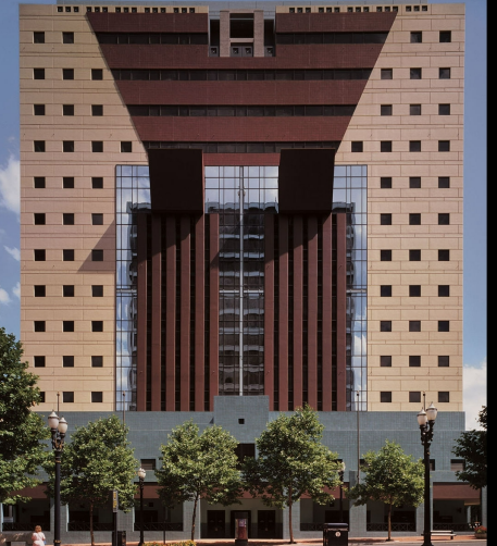 <p>Uses cartoonish classical refrences with massive colored pilasters, mirror-glass ribbon windows, and was very controversial against being an eye sore or not. With this, the Keystone motif above the main entrance is widly out of scale ond is meant to reject post-modernism</p>