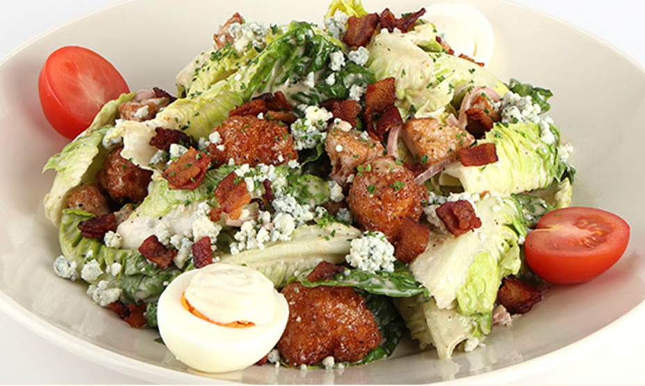 <p>Crispy Fried Chicken, Mixed Greens, Bacon, Blue Cheese, Tomato, Cucumber and Onion with Our Honey-Dijon Vinaigrette</p>