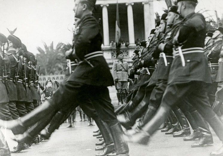 <p>a political ideology that centers on strong centralized authority, nationalism, and social unity, often suppressing individual freedoms in order to maintain control and promote the power of the state</p>