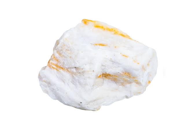 <p>dense white mineral with an orange to red film</p>
