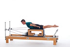 <p><strong>Setup</strong></p><ul><li><p>Starting in Pulling Straps 1 position (page 83), arms in T position, parallel to floor, hands through the straps, palms facing down</p></li><li><p>Resistance: light | <strong>Springs: 1B or 1R</strong></p></li></ul><p><strong>Movement</strong></p><ul><li><p>Inhale: Lift trunk, move arms to sides of body</p></li><li><p>Exhale: Lower trunk, move arms to T position, return to start position</p></li></ul><p><strong>Muscle Focus</strong></p><ul><li><p>Spinal extensors</p></li><li><p>Hip extensors</p></li><li><p>Shoulder adductors</p></li><li><p></p></li><li><p>Shoulder horizontal adductors</p></li></ul><p><strong>Objectives</strong></p><ul><li><p>Spinal extensor strength</p></li><li><p>Hip extensor control</p></li><li><p>Shoulder adductor control</p></li></ul><p><strong>Cues</strong></p><ul><li><p>Move arms on horizontal line, parallel to floor</p></li><li><p>Emphasize mid and upper back extensors</p></li><li><p>Keep palms facing floor</p></li><li><p>Keep legs parallel to floor</p></li></ul><p></p>