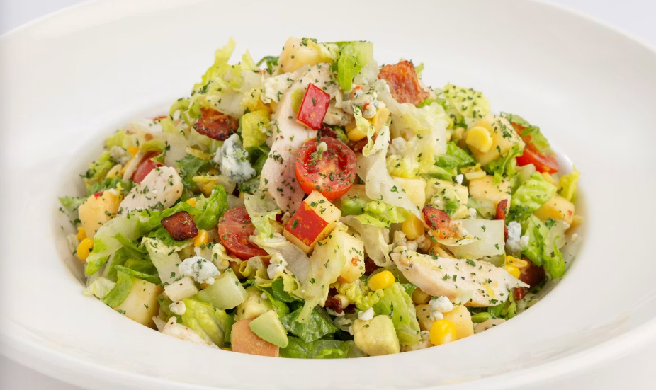 <p>A Delicious Blend of Julienne Romaine, Chicken Breast, Tomato, Avocado, Corn, Bacon, Blue Cheese and Apple with Our Vinaigrette</p>