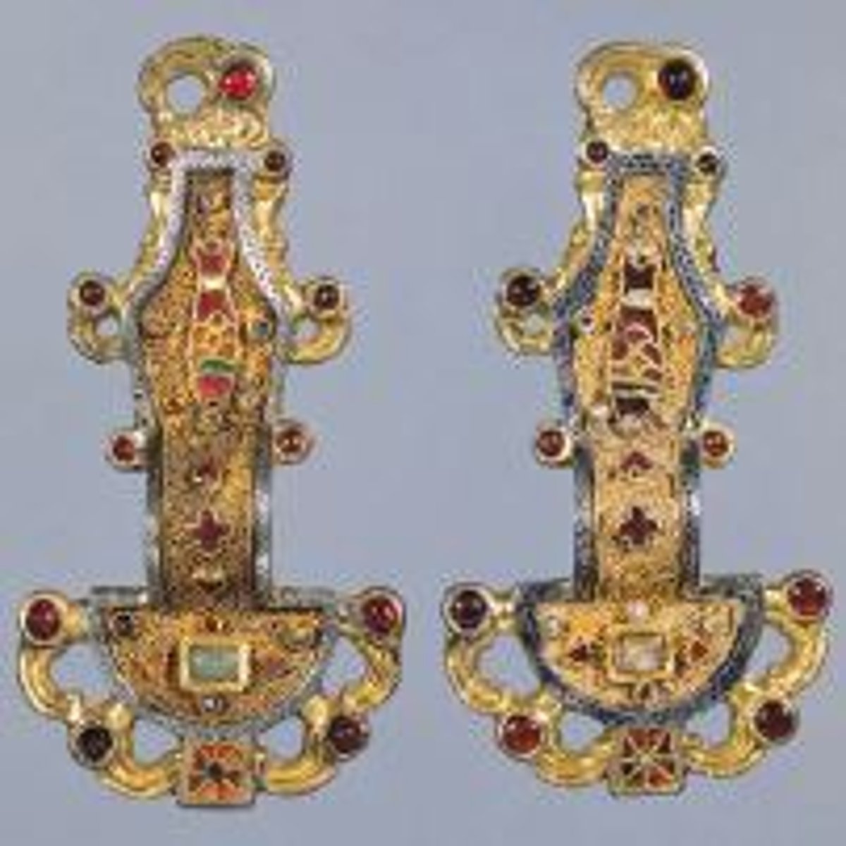 <p>fine metal wire used to create small cellular units that are filled with color - piece is then fired resulting in hard enamel like surfaces</p>