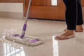 <p>The woman is mopping the floor.</p>