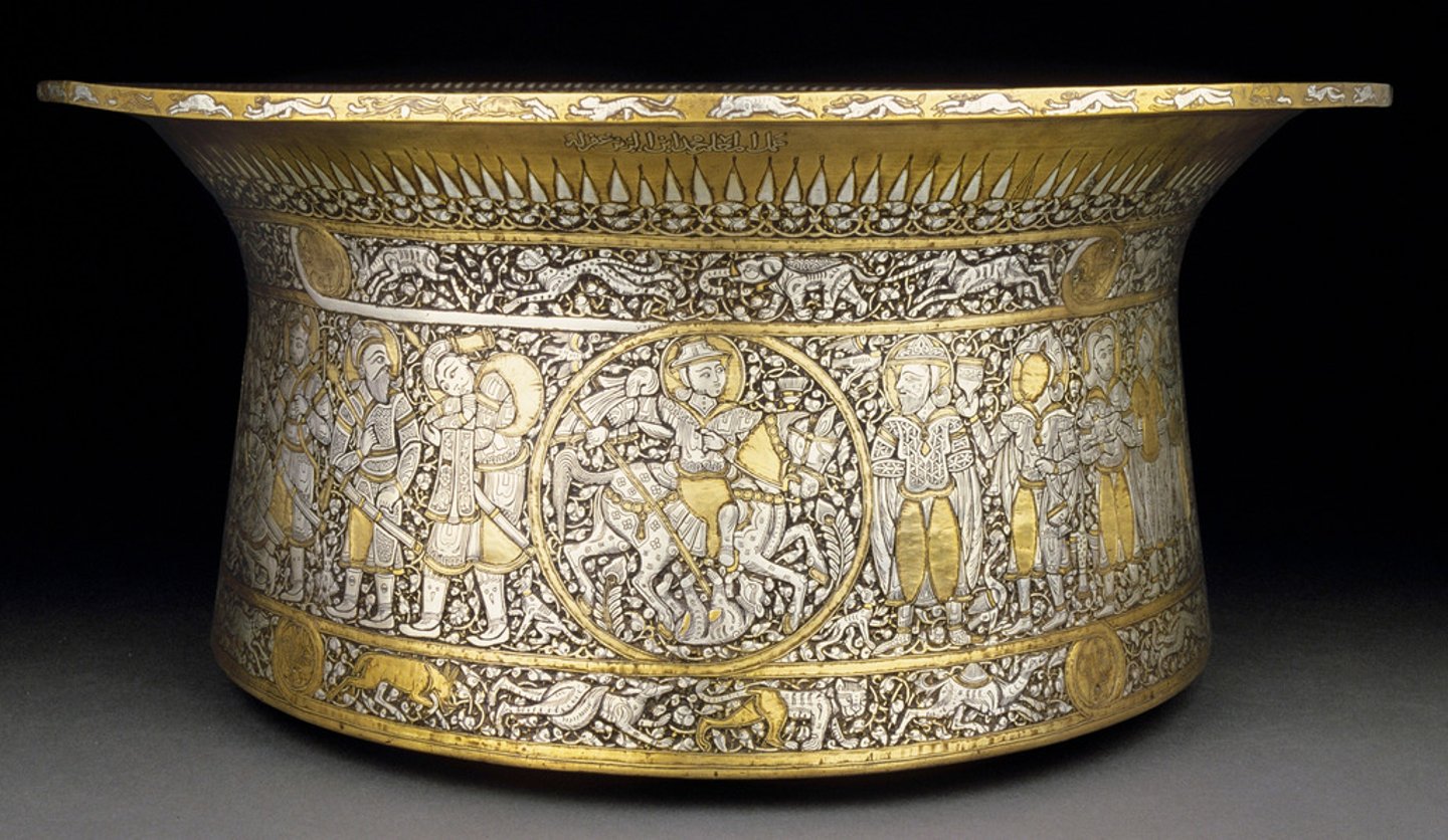 <p>Artist: Muhammad ibn al-Zain</p><p>Period:</p><p>Dates: 1320-1340 C.E.</p><p>Culture:</p><p>Material: Brass inlaid with gold and silver</p>