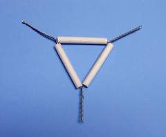 <p>Wire frame with porcelain supports; used to support a crucible</p>