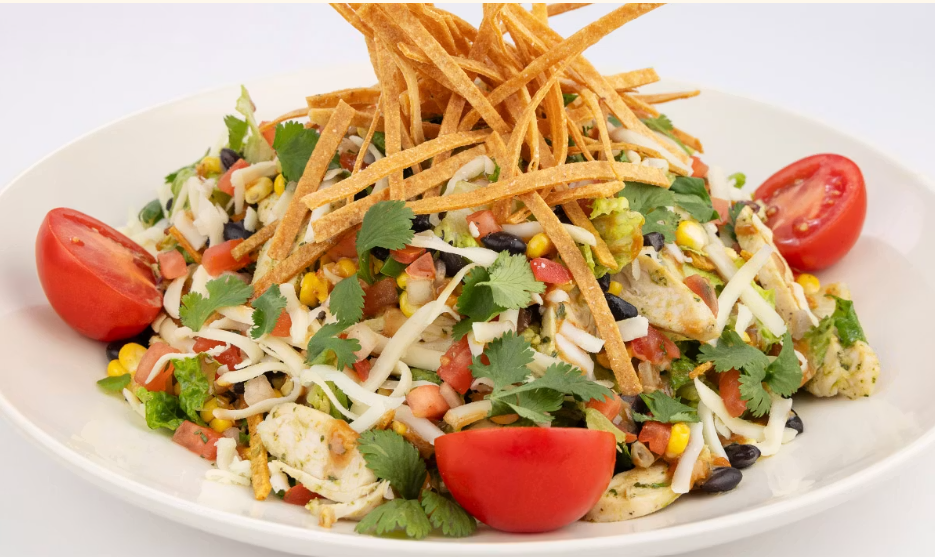 <p>Marinated Chicken, Fresh Corn, Black Beans, Cheese, Tortilla Strips, Tomato and Romaine with a Spicy Peanut-Cilantro Vinaigrette</p>
