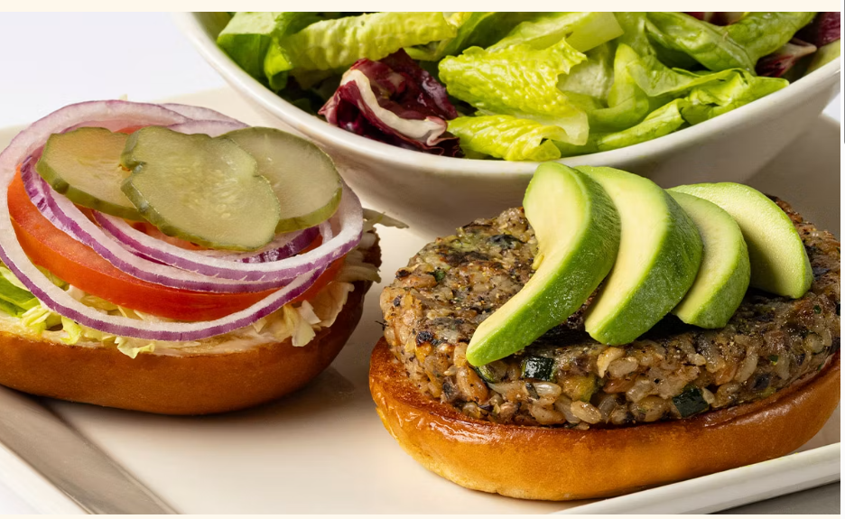 <p>Our Housemade Veggie “Burger” with Avocado, Lettuce, Tomato, Pickles and Onions on a Toasted Bun. Served with a Green Salad</p>