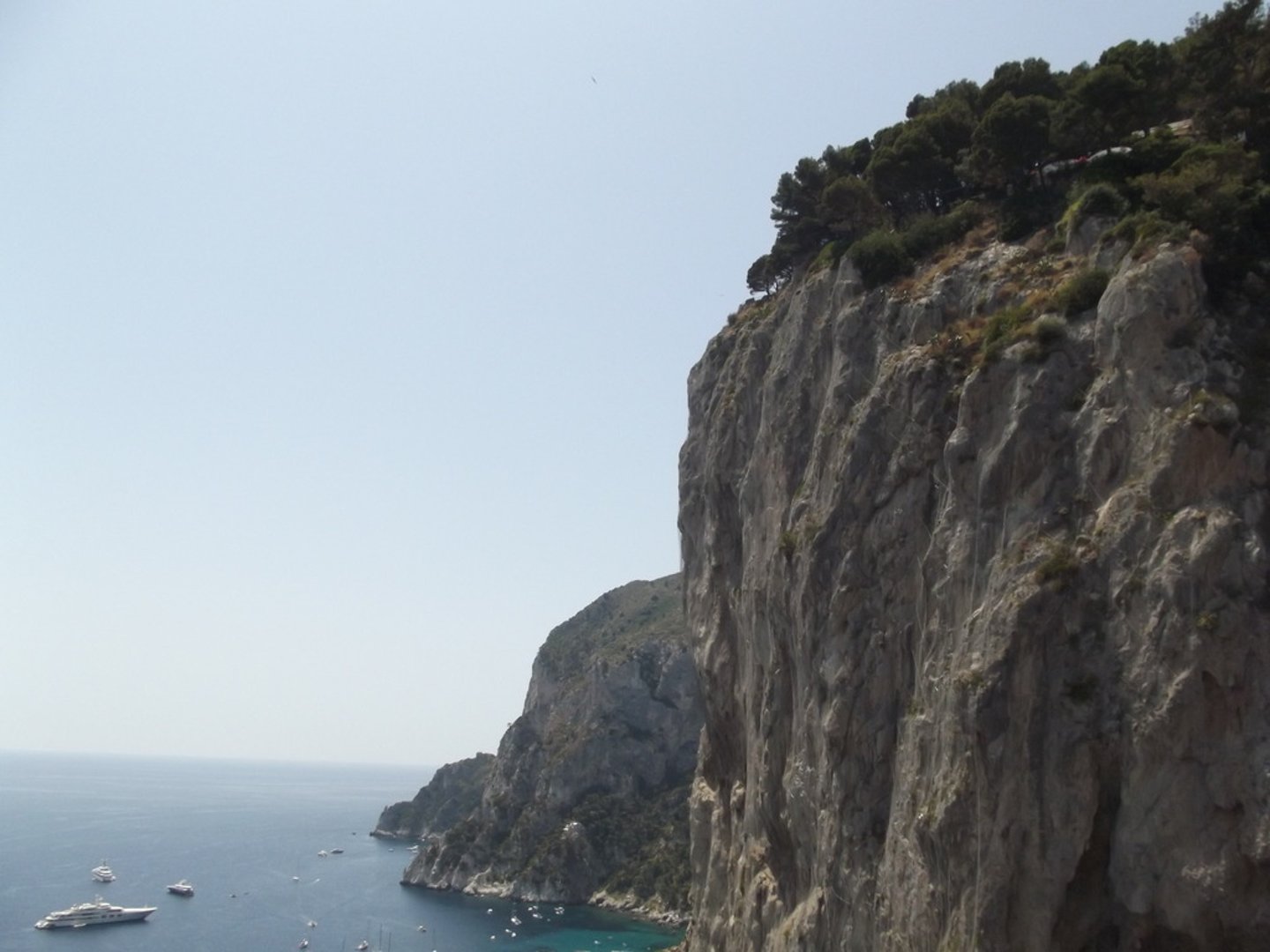 <p>steep, high wall of rock</p>