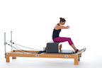 <p><strong>Setup</strong></p><ul><li><p>Sitting upright at front of Long Box, knees bent, feet under foot strap, hip width apart, arms crossed and resting on chest</p></li><li><p>Resistance: <strong>all springs attached to hold carriage in place</strong></p></li></ul><p><strong>Movement</strong></p><ul><li><p>Exhale: Round trunk into C curve, shoulders above hip joints, lift arms parallel to floor, lower trunk back</p></li><li><p>Inhale: Pause</p></li><li><p>Exhale: Lift trunk to sitting C curve</p></li><li><p>Inhale: Straighten back and lower arms, return to start position</p></li></ul><p><strong>Muscle Focus</strong></p><ul><li><p>Spinal flexors</p></li><li><p>Spinal extensors</p></li><li><p>Hip flexors</p></li></ul><p><strong>Objectives</strong></p><ul><li><p>Spinal flexor control</p></li><li><p>Spinal extensor control</p></li><li><p>Hip flexor control</p></li><li><p>Trunk stabilization</p></li></ul><p><strong>Cues</strong></p><ul><li><p>Initiate with trunk flexion prior to lowering trunk back</p></li><li><p>Maintain C curve position during lowering and lifting phases</p></li><li><p>In final phase extend trunk when shoulders are above hip joints</p></li></ul><p></p>