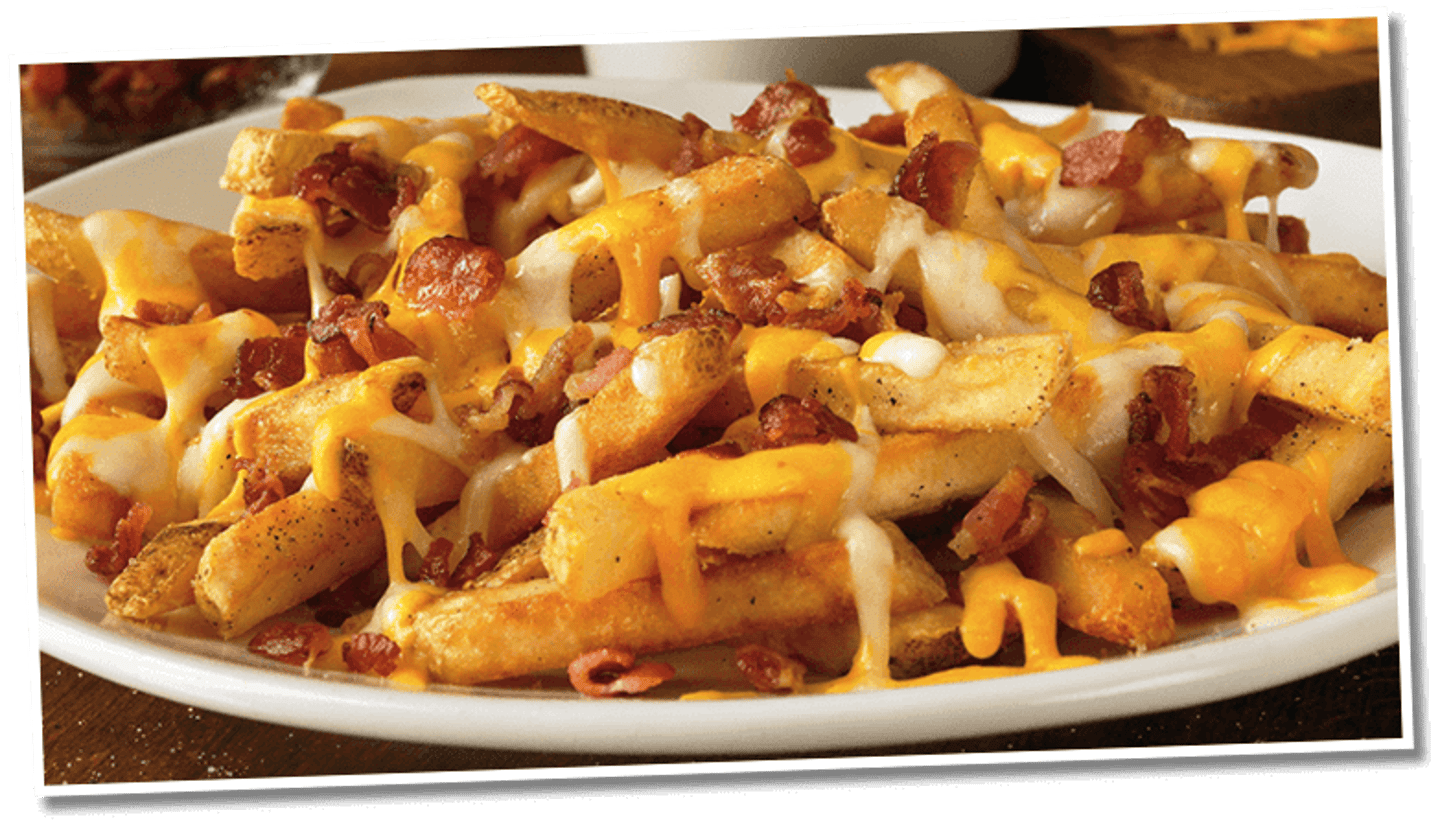 <p>Seasoned French fries, topped with melted Monterey Jack and Cheddar cheese, topped with bacon, and served with house-made ranch dressing.</p>