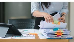 <p>She is sorting through some papers.</p>