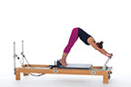 <p><strong>Setup</strong></p><ul><li><p>Standing on carriage, legs straight, heels against shoulder rests, arms straight, shoulder width apart, hands placed on footbar, head between arms, pelvis lifted toward ceiling, back flat</p></li><li><p>Resistance: light to medium | <strong>Springs:&nbsp; 1R (or 1R+1B)</strong></p></li></ul><p><strong>Movement</strong></p><ul><li><p>Inhale: Move legs back</p></li><li><p>Exhale: Move legs forward, return to start position</p></li></ul><p><strong>Muscle Focus</strong></p><ul><li><p>Spinal extensors</p></li><li><p>Hip extensors</p></li><li><p>Hip flexors</p></li><li><p>Scapula stabilizers</p></li></ul><p><strong>Objectives</strong></p><ul><li><p>Pelvic lumbar stabilization</p></li><li><p>Hip extensor control</p></li><li><p>Hip flexor control</p></li><li><p>Scapular stabilization</p></li></ul><p><strong>Cues</strong></p><ul><li><p>Keep tailbone reaching upwards</p></li><li><p>Emphasize "in" phase of movement</p></li><li><p>Focus on hip disassociation</p></li><li><p>Keep trunk and shoulders stable</p></li></ul><p></p>