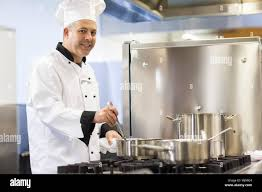 <p>The chef is stirring something in a pot.</p>