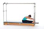 <p><strong>Setup</strong></p><ul><li><p>Sitting upright, facing PT Bar, feet pressing against poles, arms straight, shoulder width apart, hands holding PTBar</p></li><li><p>Resistance: medium</p></li></ul><p><strong>Movement</strong></p><ul><li><p>Exhale: Round trunk, glide pelvis forward leaning back, press bar down, transfer trunk forward</p></li><li><p>Inhale: Straighten trunk keeping PTBar still</p></li><li><p>Exhale: Round trunk, glide pelvis forward leaning back, lift arms</p></li><li><p>Inhale: Straighten trunk, sit upright, return to start position</p></li></ul><p><strong>Muscle Focus</strong></p><ul><li><p>Spinal flexors</p></li><li><p>Shoulder extensors</p></li><li><p>Spinal extensors</p></li></ul><p><strong>Objectives</strong></p><ul><li><p>Spinal flexor control</p></li><li><p>Shoulder extensor control</p></li><li><p>Spinal extensor control</p></li><li><p>Hip extensor stretch</p></li></ul><p><strong>Cues</strong></p><ul><li><p>Keep arms straight</p></li><li><p>Differentiate between movement of trunk and arms</p></li></ul><p></p>