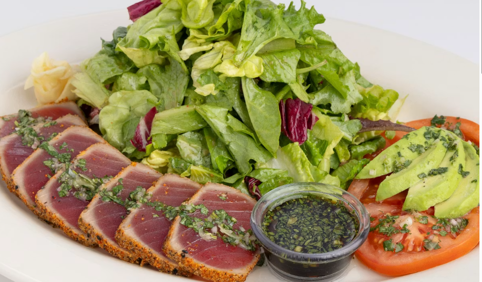 <p>Sushi Grade Ahi Seared Rare, Avocado, Tomato, Sesame, Soy and Cilantro with Mixed Greens Tossed in Shallot Vinaigrette</p>