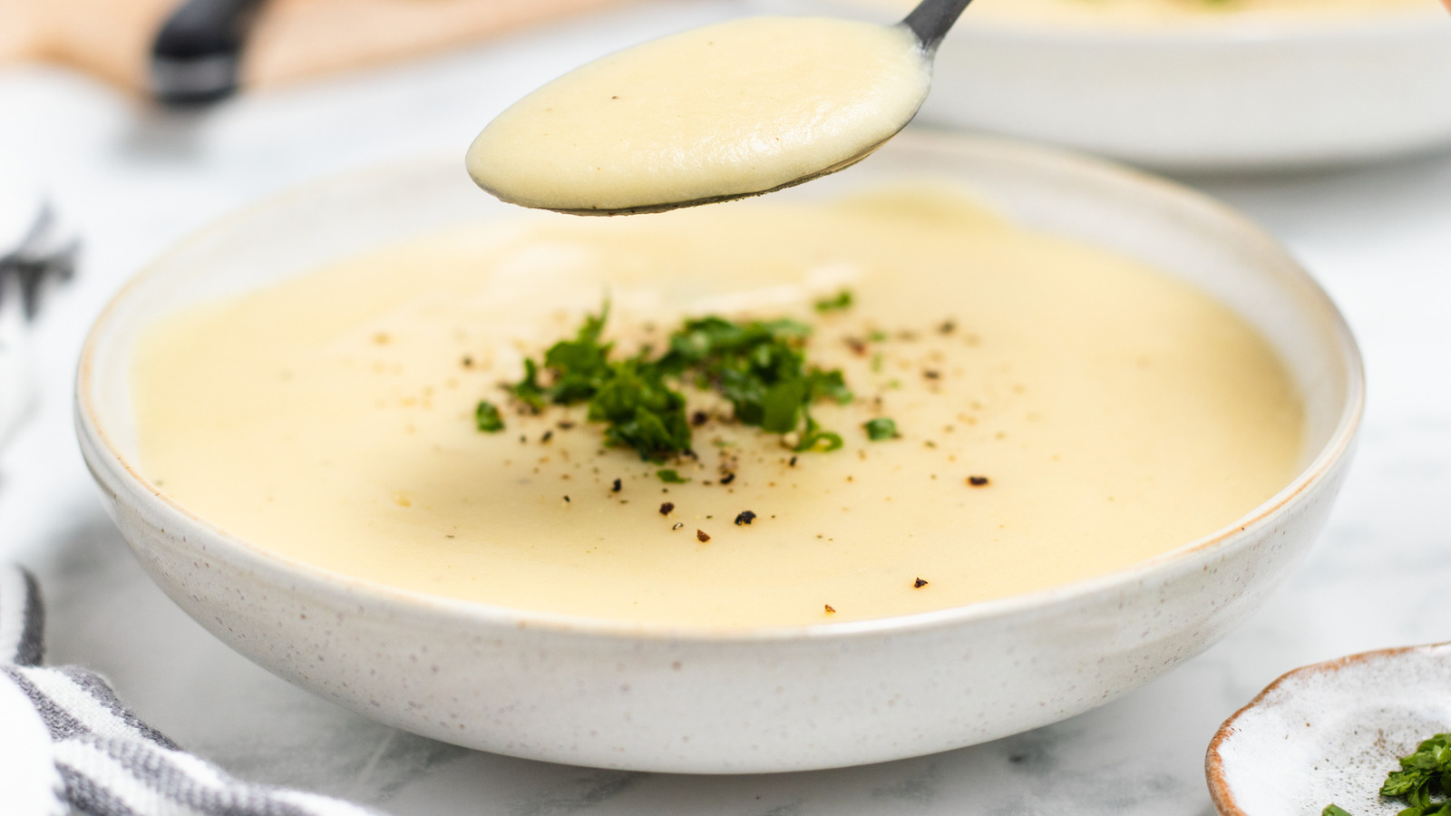 <p>silky</p><p>(The soup has a silky texture because of the coconut milk.)</p>