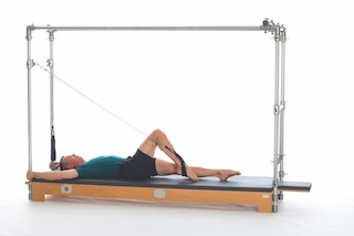 <p><strong>Setup</strong></p><ul><li><p>Lying supine in neutral spine position, legs parallel, one leg perpendicular to mat, one foot in strap, plantarflexed, other leg placed on mat, leg straight, foot plantarflexed, hands holding F2 Handles, arms bent at 90 degrees in elbow and shoulder joint or arms straight overhead, holding poles, thumbs wrapped around</p></li><li><p>Socket: F, Lever Orientation: 0, Lever Length: 1, Lever Direction: 2, Connector:N/A, Spring: N/A</p></li><li><p>Resistance: light to medium</p></li></ul><p><strong>Movement</strong></p><ul><li><p>Exhale: Lower leg</p></li><li><p>Inhale: Bend knee, flex hip bringing leg toward chest, straighten leg toward ceiling, return to start position</p></li><li><p>Reverse direction after 5 complete cycles</p></li></ul><p><strong>Muscle Focus</strong></p><ul><li><p>Hip extensors</p></li><li><p>Knee extensors</p></li><li><p>Spinal flexors</p></li><li><p>Spinal extensors</p></li></ul><p><strong>Objectives</strong></p><ul><li><p>Hip extensor control</p></li><li><p>Hip disassociation</p></li><li><p>Pelvic lumbar stabilization</p></li></ul><p><strong>Cues</strong></p><ul><li><p>Maintain spring tension</p></li><li><p>Establish L shape with legs in each cycle</p></li><li><p>Keep leg parallel avoiding hip external rotation</p></li><li><p>Maintain pelvic lumbar stabilization</p></li><li><p>Keep supporting leg elongated and stable</p></li></ul><p></p>