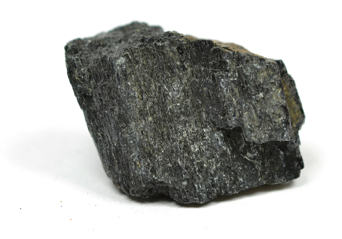 <ul><li><p>Long, jet black cleavage fragments</p></li><li><p>Commonly has tiny biotite flakes in the fragments</p></li></ul><p></p>