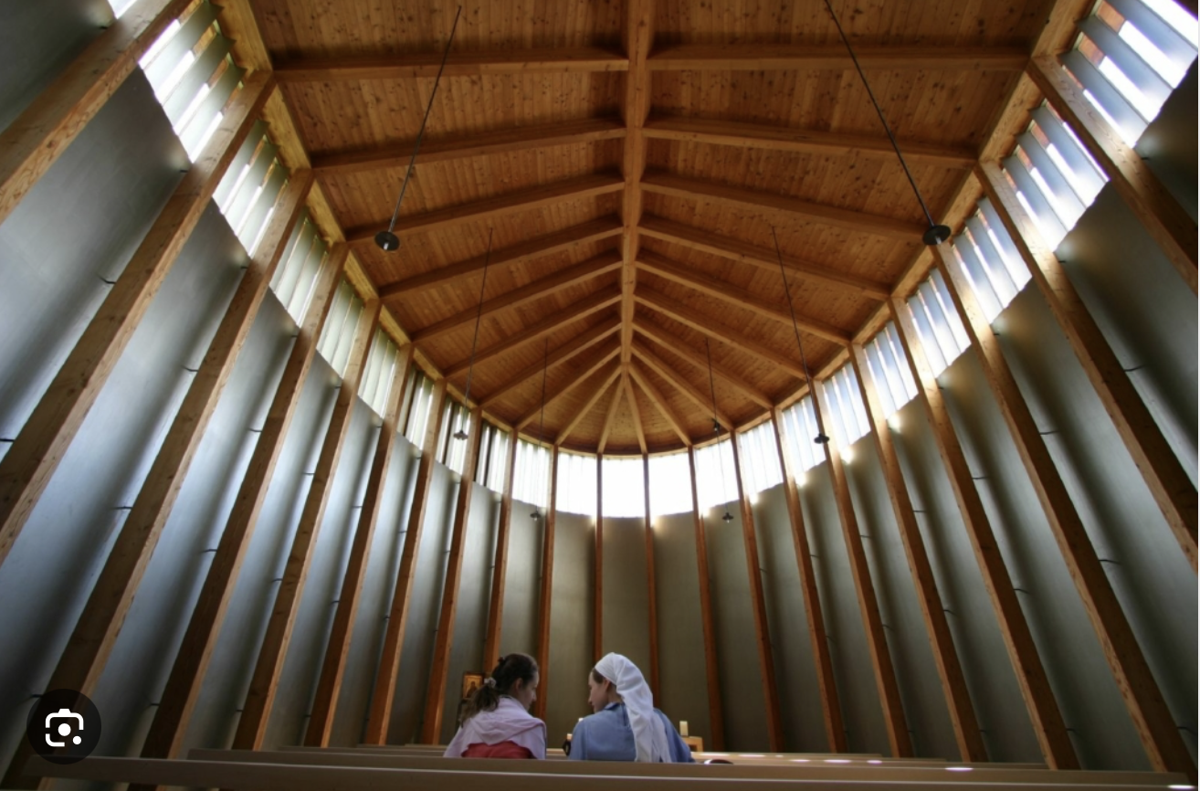 <p>Sumvitg, Switzerland; Saint Benedict Chapel; Peter Zumthor; 1988</p><ol><li><p><span>Built after a 1984 avalanche destroyed the village's original chapel, the 1988 structure is a resilient, modern intervention designed to blend into the mountainous landscape while honoring traditional Alpine wood craftsmanship.</span></p></li><li><p><span>Peter Zumthor created a unique, leaf-shaped, or "boat-like" structure that uses vertical timber columns, a ring of light, and delicate structural wooden components to create a serene, minimalist interior focused on the sensory experience of space.</span></p></li><li><p><span>The chapel demonstrates masterful use of local wood, particularly its shingled exterior cladding and timber-framed interior, exemplifying a "phenomenological" approach where material honesty and natural light foster a profound sense of calm and spiritual presence.</span></p></li></ol><p></p>