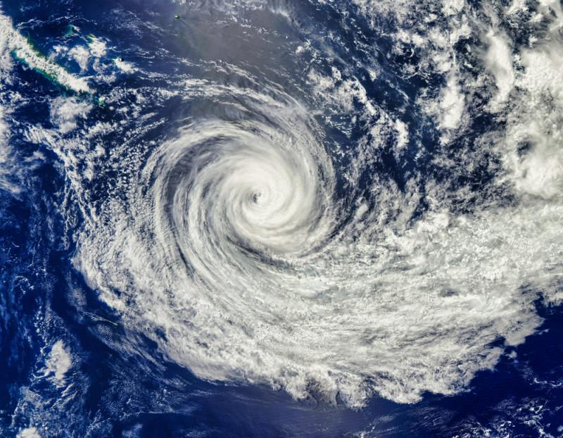 <p>(n) A large rotating storm characterized by strong winds and low atmospheric pressure.</p>