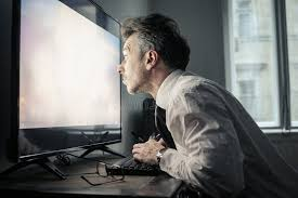 <p>He is staring at a screen.</p>