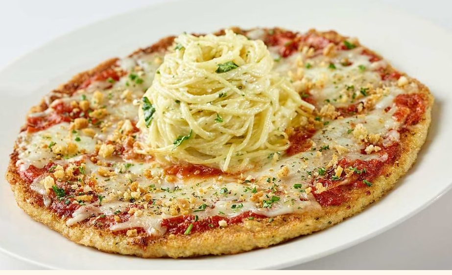 <p>Chopped Chicken Breast Coated with Breadcrumbs, Covered with Marinara Sauce and Lots of Melted Cheese. Topped with Angel Hair Pasta in an Alfredo Cream Sauce.</p>