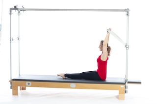 <p><strong>Setup</strong></p><ul><li><p>Lying supine in neutral spine position, arms straight and shoulder width apart, hands holding PTBar, legs straight and together, feet plantarflexed<br><strong>[no load = no springs]</strong></p></li></ul><p><strong>Movement</strong></p><ul><li><p>Inhale: Lift head and chest</p></li><li><p>Exhale: Roll up to upright sitting position,arms overhead</p></li><li><p>Inhale: Bend arms, straighten arms</p></li><li><p>Exhale: Roll down, return to start position</p></li></ul><p><strong>Muscle Focus</strong></p><ul><li><p>Spinal flexors</p></li><li><p>Spinal extensors</p></li><li><p>Shoulder flexors</p></li><li><p>Scapular stabilizers</p></li></ul><p><strong>Objectives</strong></p><ul><li><p>Spinal flexor and spinal extensor control</p></li><li><p>Shoulder stretch</p></li><li><p>Scapular stabilization</p></li></ul><p><strong>Cues</strong></p><ul><li><p>Bend arms until PTBar is aligned with top of head</p></li><li><p>Maintain scapular stabilization</p></li><li><p>Maintain slight shoulder external rotation and reach elbows out to sides when bending arms</p></li><li><p>Maintain trunk stabilization</p></li></ul><p></p>