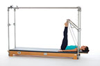 <p><strong>Setup</strong></p><ul><li><p>Lying supine, toes placed on PTBar hip width apart, legs bent</p></li><li><p>Resistance: medium to heavy <strong>[bottom loaded] 2 springs + safety belt</strong></p></li></ul><p><strong>Movement</strong></p><ul><li><p>Exhale: Straighten legs</p></li><li><p>Inhale: Bend legs, return to start position</p></li></ul><p><strong>Muscle Focus</strong></p><ul><li><p>Hip extensors</p></li><li><p>Knee extensors</p></li></ul><p><strong>Objectives</strong></p><ul><li><p>Hip extensor strength</p></li><li><p>Knee extensor control</p></li><li><p>Foot alignment and stabilization</p></li><li><p>Pelvic lumbar stabilization</p></li></ul><p><strong>Cues</strong></p><ul><li><p>Establish maximum plantarflexion when legs are straight</p></li><li><p>Keep heels stable, moving around ankle joint</p></li><li><p>Maintain hip extensor engagement</p></li><li><p>Maintain pelvic lumbar stabilization</p></li><li><p>Avoid excessive knee flexion (maximum 90 degrees)</p></li><li><p>Straighten legs completely, avoiding hyperextension</p></li></ul><p></p>