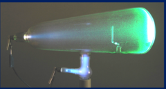 <p>by William Crookes.</p><p>glass tube filled with a small amount of gas. Electrodes (cathode/anode) in the tube allow for the passage of electricity through the gas.</p><p>-fluorsced when energized</p>