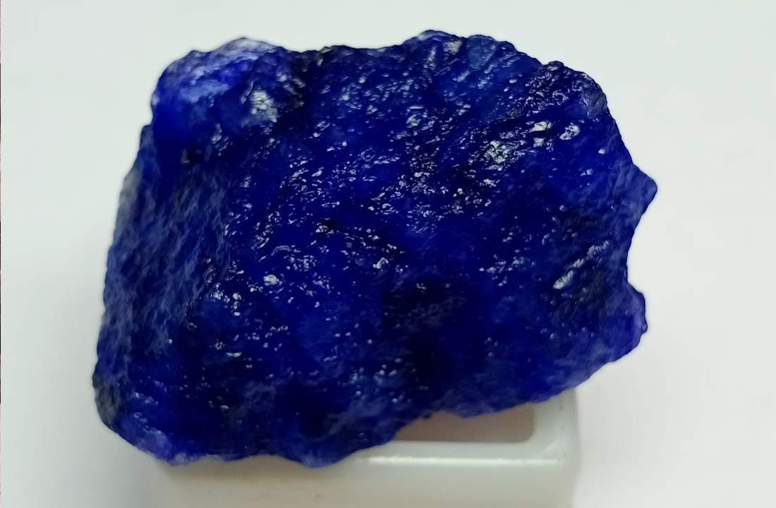 <p><strong>Maxixe</strong> is a rare variety of beryl that exhibits an intense, saturated blue color (420–470 nm), stronger than aquamarine. This color is caused by the presence of which ions, and why does it fade upon exposure to sunlight or heat?</p>