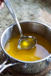 <p>A butter from which the milk solids have been removed. To create it, whole butter is melted, and the water and milk fats naturally separate from the butterfat. The butterfat portion is skimmed off; it is now clarified butter, a pure fat that does not have any milk residue.</p><p>Ghee is a type of clarified butter made from cow or buffalo milk. Traditional in India, it is cooked longer than clarified butter. Ghee can be used interchangeably with clarified butter.</p>