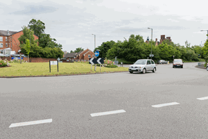What does this line across the road at the entrance to a roundabout mean?